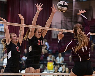 BOARDMAN, OHIO - SEPTEMBER 20, 2016: Natalie Maras #31 and Alyssa Householder #11 of Canfield go for the block of shot from Haley Blangero #11 of Boardman during the third set of their match Tuesday night at Boardman High School. DAVID DERMER | THE VINDICATOR