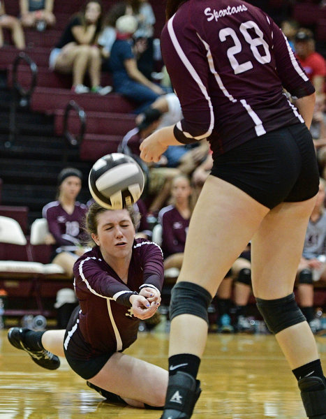 BOARDMAN, OHIO - SEPTEMBER 20, 2016: Ashley Clark #30 of Boardman falls to the floor to keep the ball alive during the third set of their match Tuesday night at Boardman High School. DAVID DERMER | THE VINDICATOR..kristen Bean #28 of Boardman pictured.