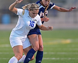 HUBBARD, OHIO - SEPTEMBER 21, 2016: Sydney Newell #16 of Hubbard and Lauren Dolak #21 of Fitch get tangled up while battling for the ball during the first half of their game Wednesday night at Hubbard Memorial Stadium. DAVID DERMER | THE VINDICATOR