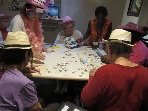 Neighbors | Alexis Bartolomucci.The pink team at Beeghly Oaks Rehabilitation Center worked hard to finish their puzzle on Aug. 23 to win the puzzle contest prize.