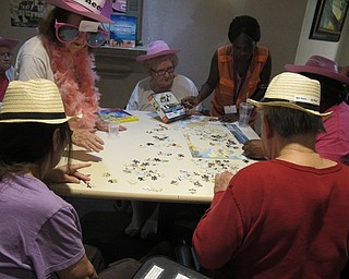 Neighbors | Alexis Bartolomucci.The pink team at Beeghly Oaks Rehabilitation Center worked hard to finish their puzzle on Aug. 23 to win the puzzle contest prize.