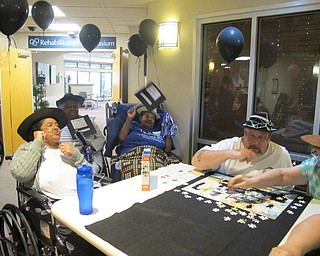 Neighbors | Alexis Bartolomucci.Cheeerleaders from the black team cheered on their team to motivate them to finish the puzzle contest at Beeghly Oaks Rehabilitation Center on Aug. 23.