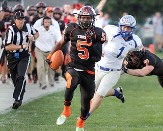 William D. Lewis/The Vindicator Howland's Tyriq Ellis(5) scampers for a 1rst qtr TD while being pursued by Hubbard'sMason Borawiec (1). during a Sept. 23,2016 game at Howland. Blocking for Howland is John Andamasaris(7).