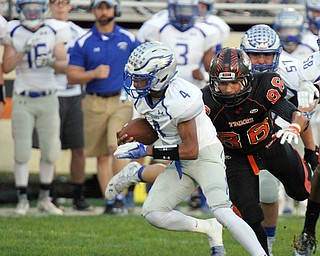 William D. Lewis/The Vindicator  Hubbard's Davion Daniels(4) is pursued by Howland's Austin Baker(86)during a Sept. 23,2016 game at Howland.