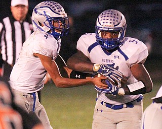 William D. Lewis/The Vindicator Hubbard's Davion Daniels(4) hands of to Rafael Morales(5) during a Sept. 23,2016 game at Howland.