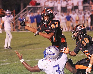 William D. Lewis/The Vindicator Howland's Jacob Williams(87) and Austin Baker(86) break up a pass intended for  Hubbard's Tryeq Moorer(3). during a Sept. 23,2016 game at Howland.