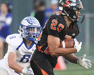 William D. Lewis/The Vindicator Howland's Victor Williams(20) scampers yardage while being pursued by Hubbard's Raymond Minnitti(8). during a Sept. 23,2016 game at Howland.