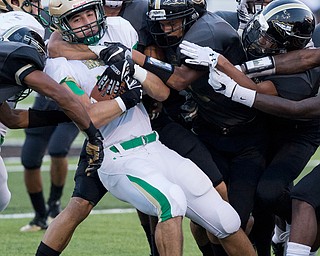 MICHAEL G TAYLOR | THE VINDICATOR- 9-23-16- 1st qtr.,Ursuline's #45 Mario Fusillo is brought down by a host of Harding tacklers. Youngstown Ursuline Irish vs Warren G Harding at Mollenkopf Stadium in Warren, OH.