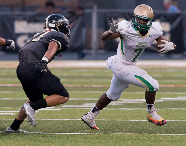 MICHAEL G TAYLOR | THE VINDICATOR- 9-23-16- 1st qtr.,Ursuline's #7 Joe Floyd gains a 1st down asn he is being persued by Harding's #13 Tre Murry. Youngstown Ursuline Irish vs Warren G Harding at Mollenkopf Stadium in Warren, OH.