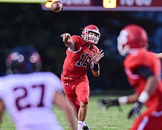 STRUTHERS, OHIO - SEPTEMBER 23, 2016: AJ Musolino #18 of Struthers throws a pass downfield to Jacob Shaffer #4 while he is covered by Paul French #27 of Canfield during the first half of their game Friday night at Struthers High School. DAVID DERMER | THE VINDICATOR
