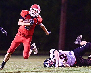 STRUTHERS, OHIO - SEPTEMBER 23, 2016: Vinnie Fiorenza #2 of Struthers runs the football after breaking out of a would be tackle by Cody Holland #42 of Canfield during the first half of their game Friday night at Struthers High School. DAVID DERMER | THE VINDICATOR