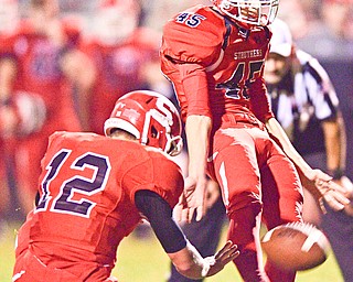 STRUTHERS, OHIO - SEPTEMBER 23, 2016: Kicker Derek Guzzo #45 of Struthers kicks a field goal to go up by 10 point late in the 4th quarter out of the half of JD Hall #12 , Friday night at Struthers High School. DAVID DERMER | THE VINDICATOR