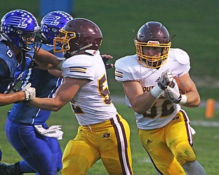 Nathan Daniszewski (32) of South Range picks up a great block from teammate Levi Taylor (52) on Marcus Nenichka (6) of Lisbon during the first quarter of Friday nights matchup in Lisbon.   Dustin Livesay  |  The Vindicator  9/23/16  Lisbon.