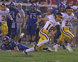 South Range punt returner Mathias Combs (18) outruns Lisbons Marcus Nenichka (6) to return a punt all the way for a touchdown during the second quarter of Friday nights matchup in Lisbon.   Dustin Livesay  |  The Vindicator  9/23/16  Lisbon.