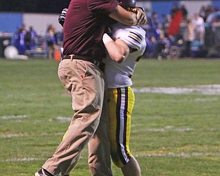 South Range head coach Dan Yeagley hugs Trent Harrold (36) after the Raiders returned a punt back for a touchdown during the second quarter of Friday nights matchup in Lisbon.   Dustin Livesay  |  The Vindicator  9/23/16  Lisbon.