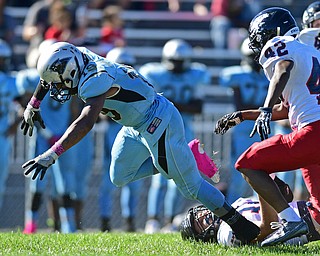 YOUNGSTOWN, OHIO - SEPTEMBER 24, 2016: Leon Bell #19 of East chases after the football after fumbling after being hit by Bryce Warmouth #34 of Fitch in the backfield and before being tackled for a loss by Emmanuel Dawkins #42 during the second half of their game Saturday afternoon at Rayen Stadium. Fitch won 38-6. DAVID DERMER | THE VINDICATOR