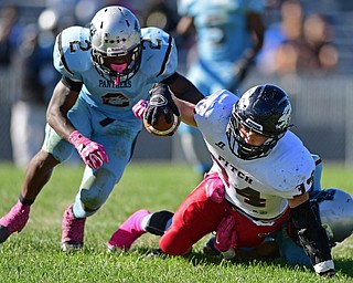 YOUNGSTOWN, OHIO - SEPTEMBER 24, 2016: Bryce Warmouth #34 of Fitch reaches out with the football for extra yardage while being brought down by Michael Lawrence #2 and #6 (name not on roster sheet) during the second half of their game Saturday afternoon at Rayen Stadium. Fitch won 38-6. DAVID DERMER | THE VINDICATOR