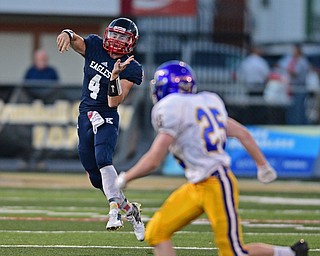 WARREN, OHIO - SEPTEMBER 24, 2016: Gregory Valent #4 of JFK throws a pass on the run while Brody Mihalyo #25 of Steubenville Central Catholic drops back in coverage during the first half of their game Saturday night at Mollenkopf Stadium. DAVID DERMER | THE VINDICATOR
