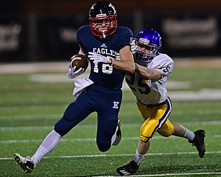 WARREN, OHIO - SEPTEMBER 24, 2016: Thomas Yanovich #16 of JFK is brought down from behind by Brody Mihalyo #25 of Steubenville Central Catholic during the first half of their game Saturday night at Mollenkopf Stadium. DAVID DERMER | THE VINDICATOR
