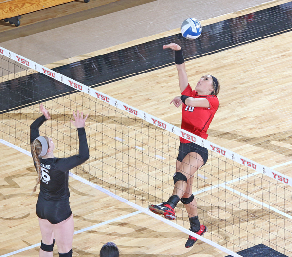 Youngstown State's erin Kalahar (10) hits the ball over the jumping block by Cleveland State's Sara Skeens (16) during the second set of Sunday afternoons matchup at the Beeghly Center.   Dustin Livesay  |  The Vindicator  9/25/16  Beeghly Center,  YSU