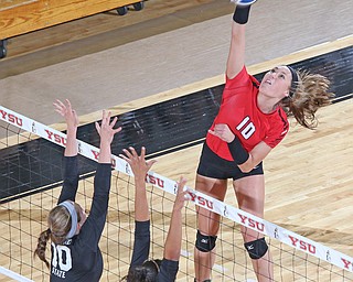 Youngstown State's Erin Kalahar (10) spikes the ball at the block set up by Cleveland State's Grace Kauth (10) and Aaliyah Slappy (3) during the second set of Sunday afternoons matchup at the Beeghly Center.   Dustin Livesay  |  The Vindicator  9/25/16  Beeghly Center,  YSU