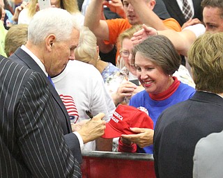 Gov. Mike Pence autographs a cap for Kathy Miller of Boardman during a Sept. 28, 2016 campaign stop in Leetonia, OH.
