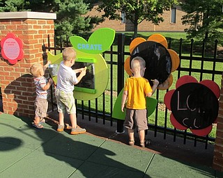 Neighbors | Alexis Bartolomucci.Children painted on the paint wall at the outdoor STEAM station at the Boardman library grand opening of the new learning stations on Sept. 10.