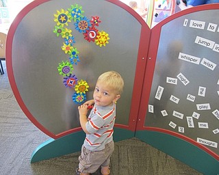 Neighbors | Alexis Bartolomucci.Oliver played with the magnetic cog wall at the Boardman library on Sept. 10 during the grand opening of the indoor and outdoor learning stations.
