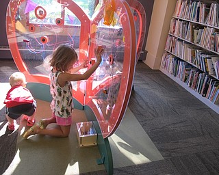 Neighbors | Alexis Bartolomucci.Two of the children at the Boardman library learning center grand opening on Sept. 10 played with the new circuit wall that lights up and makes a fan blow when different buttons are pressed.