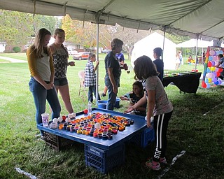 Neighbors | Alexis Bartolomucci.One of the children attending the Family Funday Carnival on Sept. 17 at Poland United Methodist Church tossed a ball into cups to win tickets for a prize.