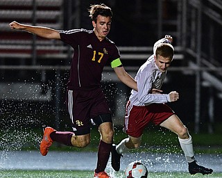 CANFIELD, OHIO - SEPTEMBER 29, 2016: Tanor English #3 of Canfield and Mitch McConnell #17 of South Range chase after the ball through a puddle during the first half of their game Thursday night at Canfield High School. DAVID DERMER | THE VINDICATOR
