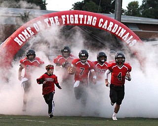 Nikos Frazier | The Vindicator..The Canfield Cardinals storm onto the field before taking on the Boardman Spartans on Friday, Sept. 30 2016.