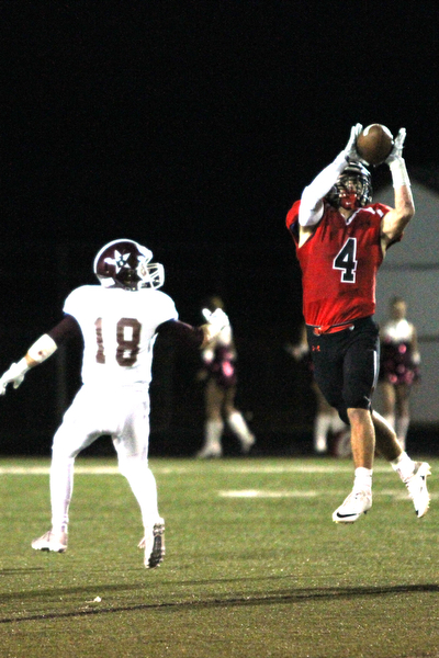 Nikos Frazier | The Vindicator..Cardinal Paul Breinz(4) catches an interception in the second quarter at Canfield High School on Friday, Sept. 30, 2016.