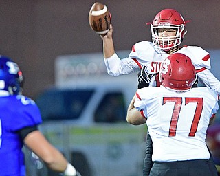 POLAND, OHIO - SEPTEMBER 30, 2016: AJ Musolino #18 of Struthers is held up by Adam Sedzmak #77 after scoring a rushing touchdown during the first half of their game Friday night at Poland High School. DAVID DERMER | THE VINDICATOR..Alec Catsoules #23 of Poland pictured.