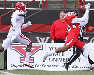 Nikos Frazier | The Vindicator..YSU's Darien Townsend(21) attempts to catch a pass as USD's Danny Rambo(26) trails behind in the first quarter at Stambaugh Stadium in Youngstown on Saturday, Oct. 1, 2016. Youngstown State University would go on to win, 30-20 against University of South Dakota.