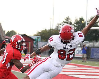 Nikos Frazier | The Vindicator..USD's Dakarai Allen(82) extends his arm asYSU's David Rivers III(31) watches the ball sail by in the third quarter at Stambaugh Stadium in Youngstown on Saturday, Oct. 1, 2016. Youngstown State University would go on to win, 30-20 against University of South Dakota.