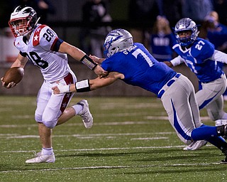 MICHAEL G TAYLOR | THE VINDICATOR- 9-30-16- 2nd qtr, Niles' #28 Robbie Savin breaks th tackle attempt by Hubbard's #7 Dillon O'Hara to pickup the 1st down on his way to a rushing TD. Niles Red Dragons vs Hubbard Eagles at Alumni Field in Memorial Stadium in Hubbard, OH.