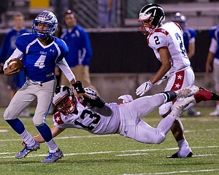 MICHAEL G TAYLOR | THE VINDICATOR- 9-30-16- 2nd qtr., Hubbard's #4 Davion Daniels is stooped from scorng a TD by Niles' #13 Tyler Srbinovich. Niles Red Dragons vs Hubbard Eagles at Alumni Field in Memorial Stadium in Hubbard, OH.