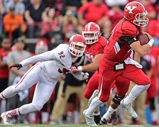 YOUNGSTOWN, OHIO - OCTOBER 1, 2016: Quarterback Ricky Davis #12 of YSU takes off to run to avoid backside pressure from Kameron Kline #92 of South Dakota during the first half of their game Saturday afternoon at Stambaugh Stadium. YSU won 30-20. DAVID DERMER | THE VINDICATOR