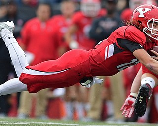 YOUNGSTOWN, OHIO - OCTOBER 1, 2016: Quarterback Ricky Davis #12 of YSU flies through the air to dive for extra yardage during the first half of their game Saturday afternoon at Stambaugh Stadium. YSU won 30-20. DAVID DERMER | THE VINDICATOR
