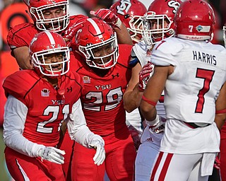 YOUNGSTOWN, OHIO - OCTOBER 1, 2016: Running back Martin Ruiz #29 of YSU celebrates with his teammates, including Dylan Colucci #77 and Darien Townsend #21, after scoring a rushing touchdown during the first half of their game Saturday afternoon at Stambaugh Stadium. YSU won 30-20. DAVID DERMER | THE VINDICATOR