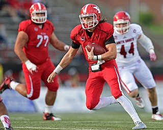 YOUNGSTOWN, OHIO - OCTOBER 1, 2016: Quarterback Ricky Davis #12 of YSU runs the football in the open field after picking up a block from Dylan Colucci #77 on Darin Greenfield #44 of South Dakota during the first half of their game Saturday afternoon at Stambaugh Stadium. YSU won 30-20. DAVID DERMER | THE VINDICATOR