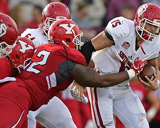 YOUNGSTOWN, OHIO - OCTOBER 1, 2016: Quarterback Chris Streveler #15 of South Dakota is brought down by defensive linemen Savon Smith #52 of YSU during the first half of their game Saturday afternoon at Stambaugh Stadium. YSU won 30-20. DAVID DERMER | THE VINDICATOR