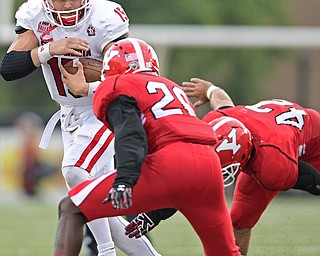 YOUNGSTOWN, OHIO - OCTOBER 1, 2016: Quarterback Chris Streveler #15 of South Dakota runs the football before being hit by safety Jameel Smith #26 of YSU and avoiding a tackle from Armand Dellovade #42 during the second half of their game Saturday afternoon at Stambaugh Stadium. YSU won 30-20. DAVID DERMER | THE VINDICATOR