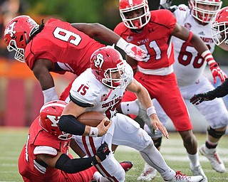 YOUNGSTOWN, OHIO - OCTOBER 1, 2016: Quarterback Chris Streveler #15 of South Dakota is brought down by Derek Rivers #11, Avery Moss #9 and David Rivers III #31 of YSU during the second half of their game Saturday afternoon at Stambaugh Stadium. YSU won 30-20. DAVID DERMER | THE VINDICATOR
