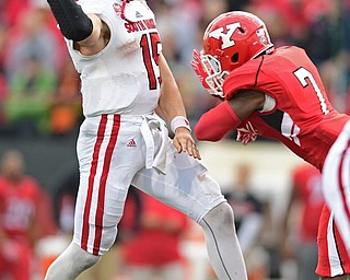 YOUNGSTOWN, OHIO - OCTOBER 1, 2016: Quarterback Chris Streveler #15 of South Dakota throws off his blackfoot before being hit hard by defensive back Kenny Bishop #7 of YSU during the second half of their game Saturday afternoon at Stambaugh Stadium. YSU won 30-20. DAVID DERMER | THE VINDICATOR