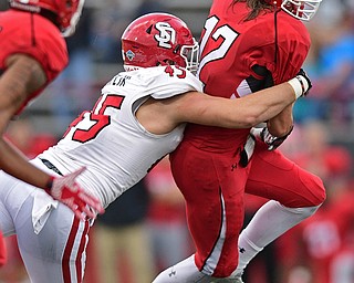 YOUNGSTOWN, OHIO - OCTOBER 1, 2016: Quarterback Ricky Davis #12 of YSU is sacked by Colin Mertlik #45 of South Dakota during the second half of their game Saturday afternoon at Stambaugh Stadium. YSU won 30-20. DAVID DERMER | THE VINDICATOR
