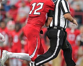 YOUNGSTOWN, OHIO - OCTOBER 1, 2016: Quarterback Ricky Davis #12 of YSU collides with the Umpire Nolan Nowak on a run, he would fall short of the first down, during the second half of their game Saturday afternoon at Stambaugh Stadium. YSU won 30-20. DAVID DERMER | THE VINDICATOR