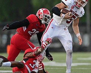 YOUNGSTOWN, OHIO - OCTOBER 1, 2016: Quarterback Chris Streveler #15 of South Dakota is brought down by David Rivers III #31 and Jameel Smith #26 of YSU during the second half of their game Saturday afternoon at Stambaugh Stadium. YSU won 30-20. DAVID DERMER | THE VINDICATOR