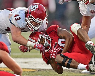 YOUNGSTOWN, OHIO - OCTOBER 1, 2016: Running back Jody Webb #20 of YSU is brought down by Jim Litrenta #43 of South Dakota during the second half of their game Saturday afternoon at Stambaugh Stadium. YSU won 30-20. DAVID DERMER | THE VINDICATOR